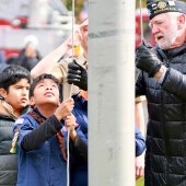 Scouts raise the flag with veteran